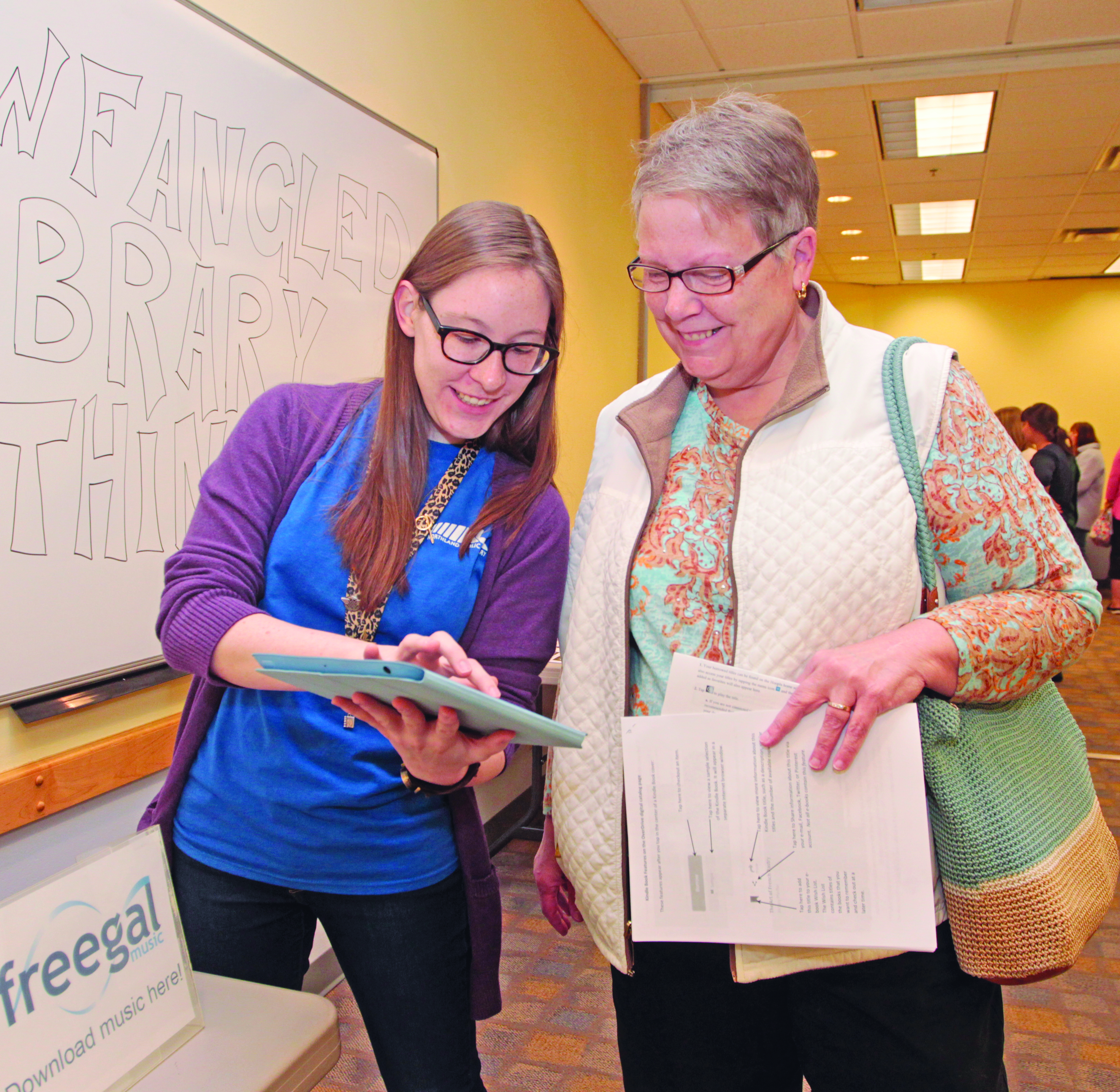 Raeann MacNeill explains how to download the latest Adele songs via the “freegal” music app to Margaret Daniels of Wexford. Photo by Chuck LeClaire